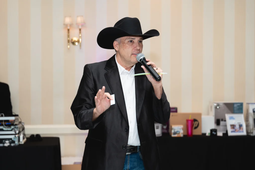 Man singing at country-themed party.