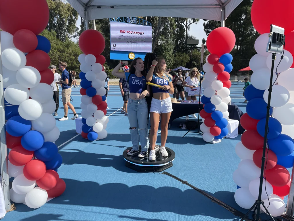 Festive photo booth experience with guests and patriotic balloon decor.