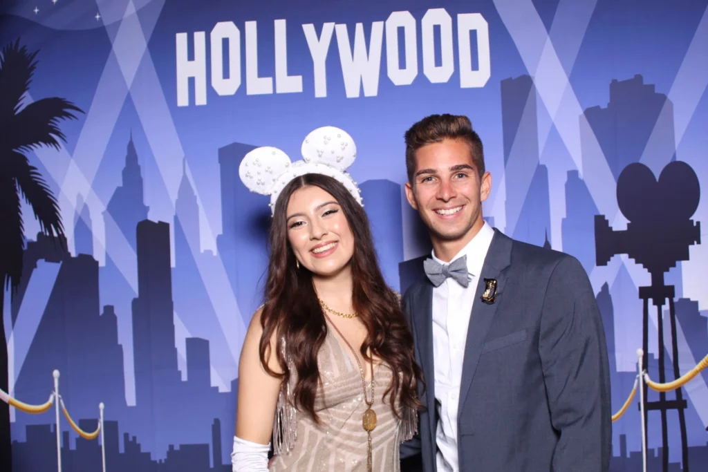 Couple dressed up at a Hollywood-themed event photo booth.