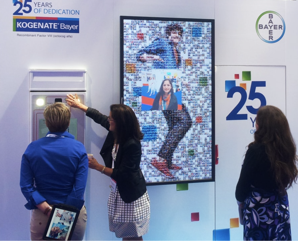 Attendees creating a photo mosaic at Bayer’s 25th anniversary event.