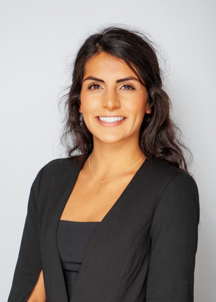 Professional headshot of a smiling woman in a business suit for corporate use.