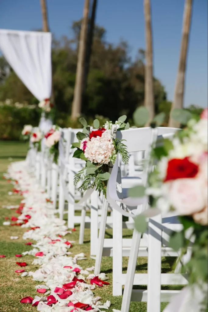 Aisle decorated with flowers and rose petals.