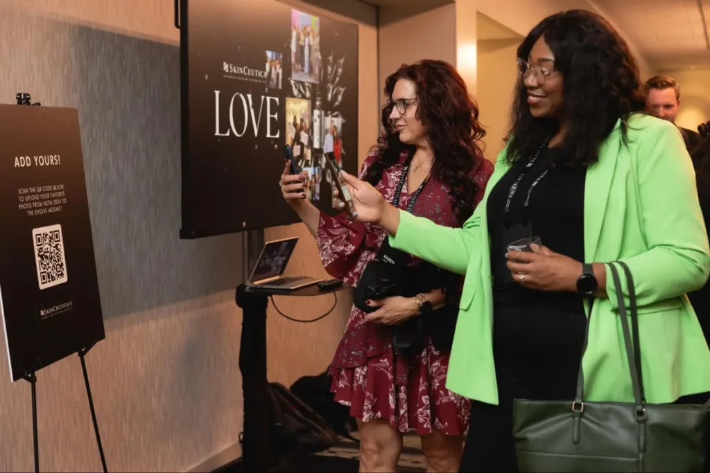 Attendees engaging with a digital photo display at a corporate event