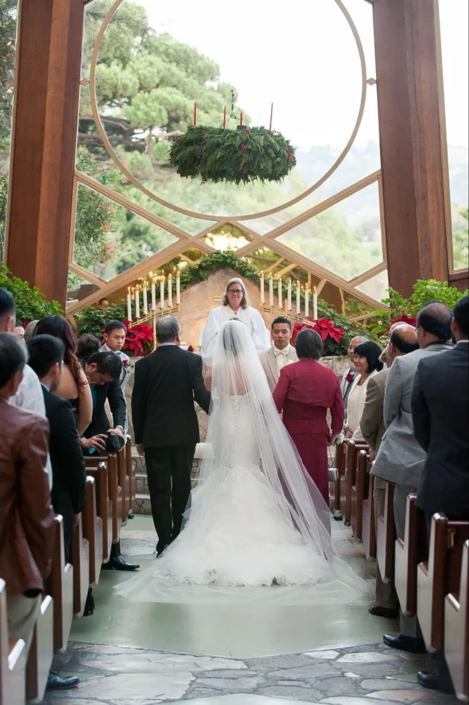 Bride walking down the aisle in a modern church setting.