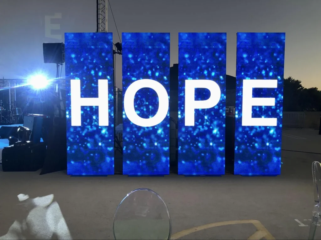 Bright LED display with 'HOPE' at a wedding reception.