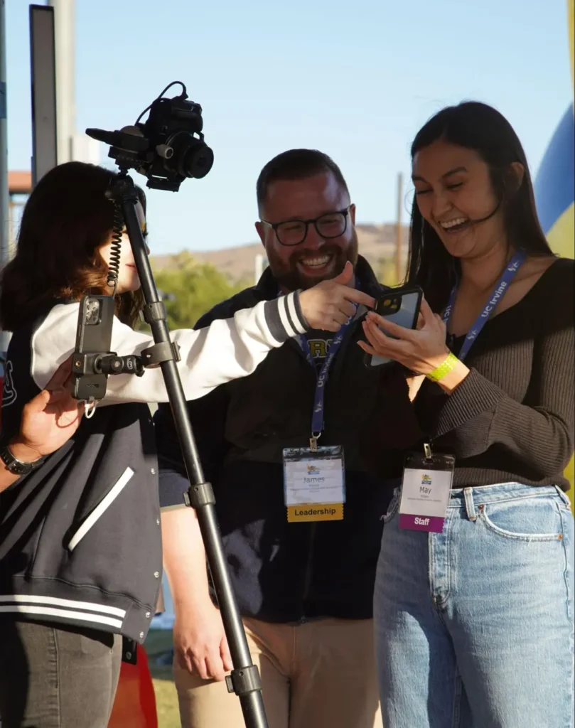 Event staff and participants engage with a camera setup, demonstrating event