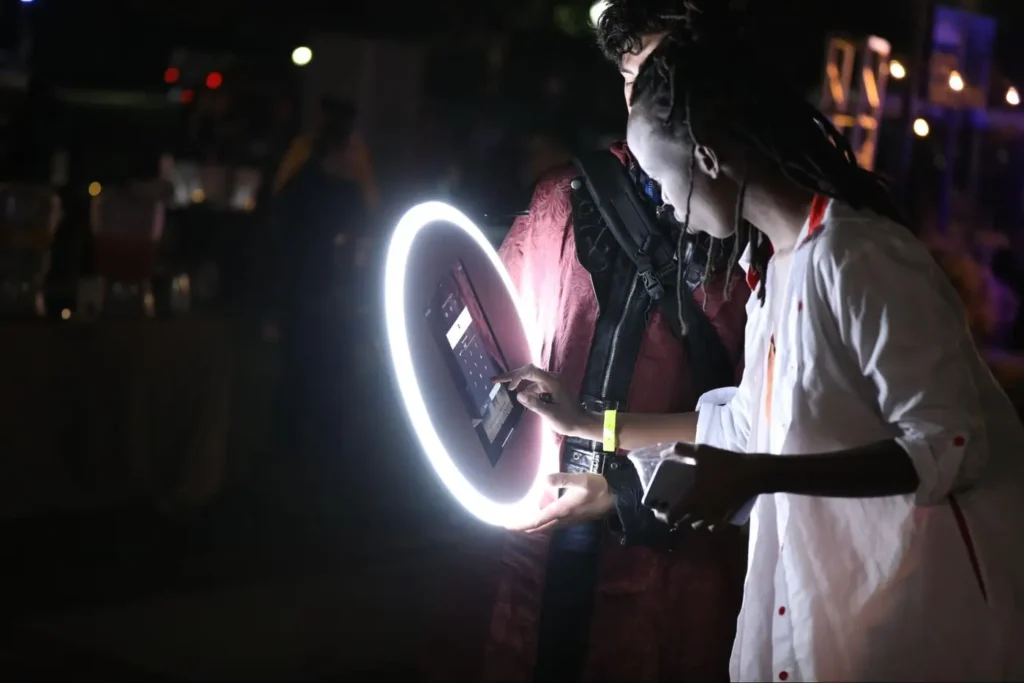 Interactive photo booth technology demonstration at a nighttime.