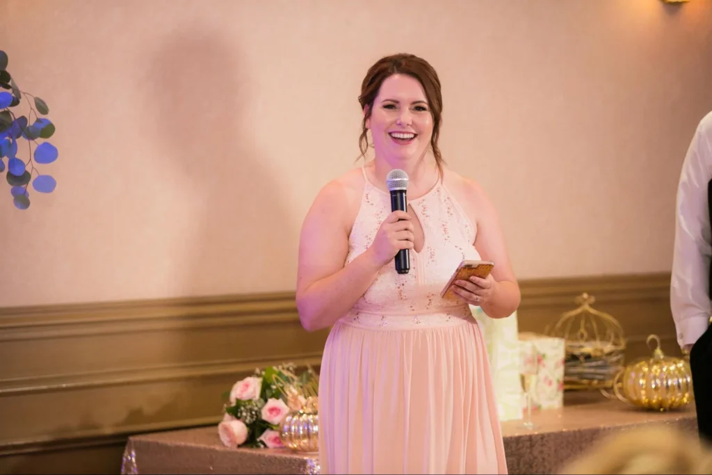 Maid of honor giving a speech at wedding reception.