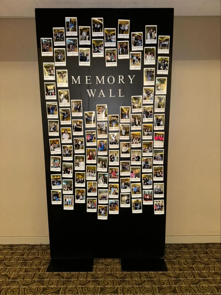 Memory wall decorated with polaroid photos at a wedding.