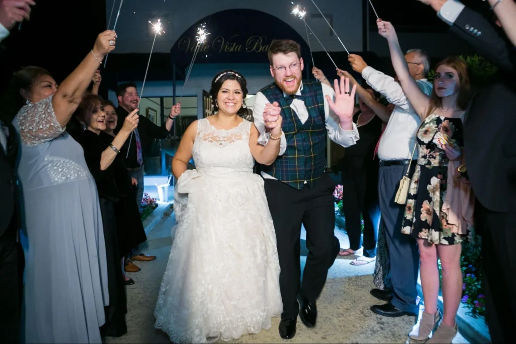 Newlyweds walking through sparkler send-off.