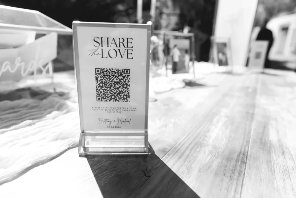 QR code wedding display encouraging guests to share their photos.