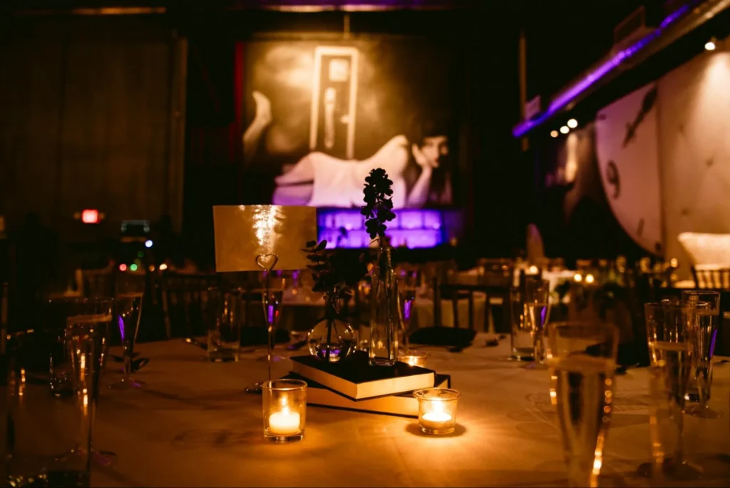 Romantic wedding dinner setup with soft lighting and gold accents.