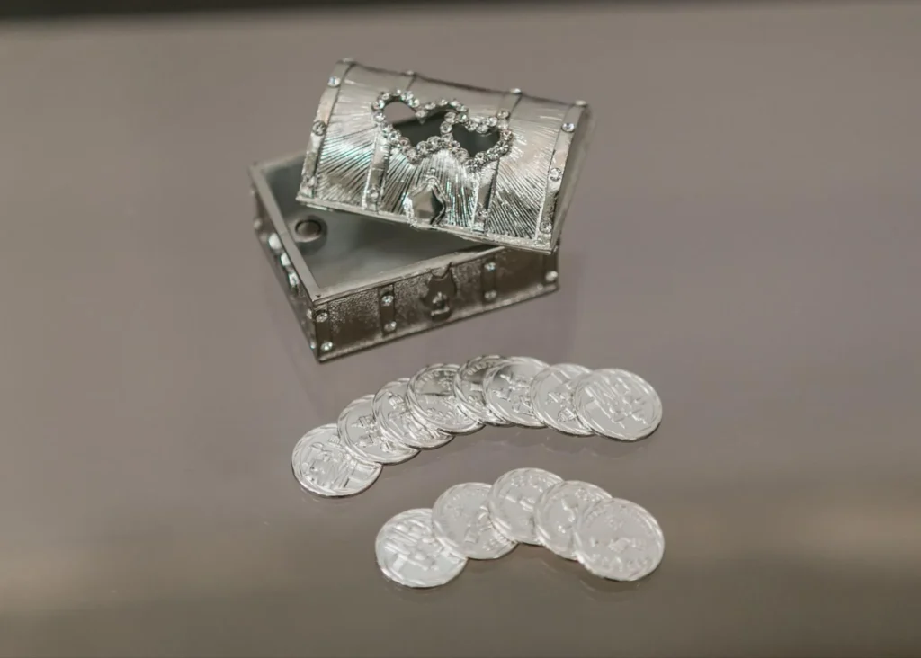 Silver treasure chest with wedding coins on display.