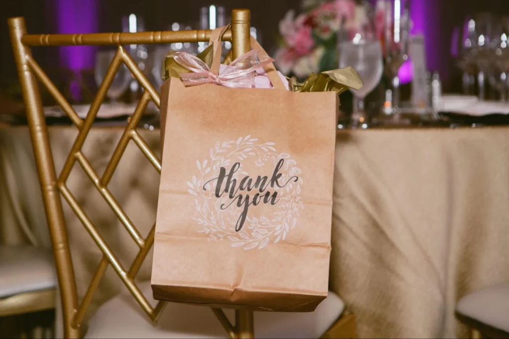 Thank you gift bag on chair at wedding reception.