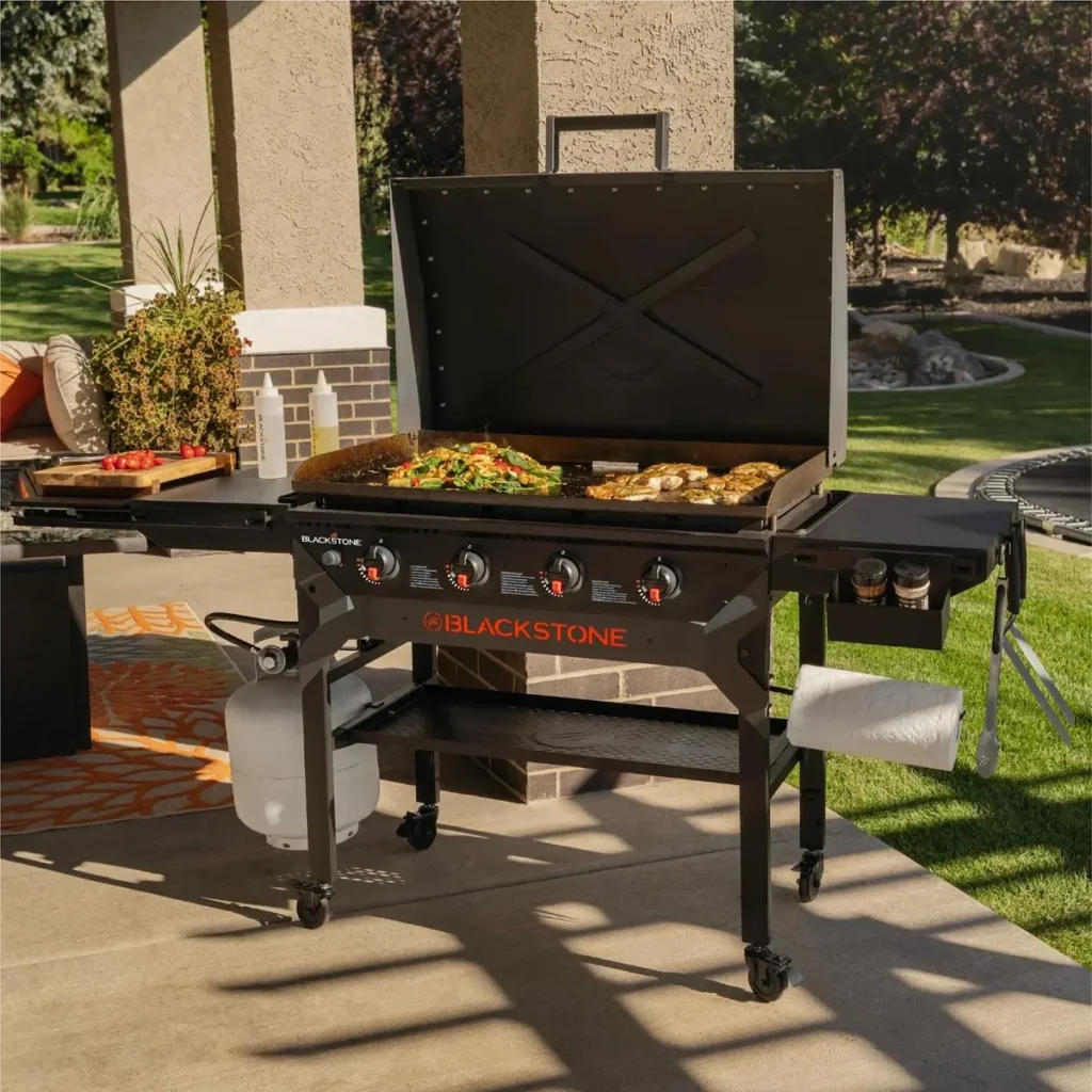 Blackstone outdoor gas griddle cooking station with side shelves and food prep area, premium BBQ raffle prize