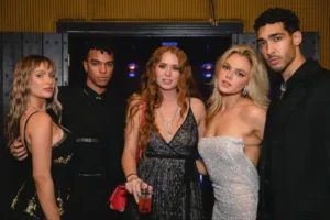 Event photography capturing group in formal attire at nightclub, showing modern low-light party photography techniques