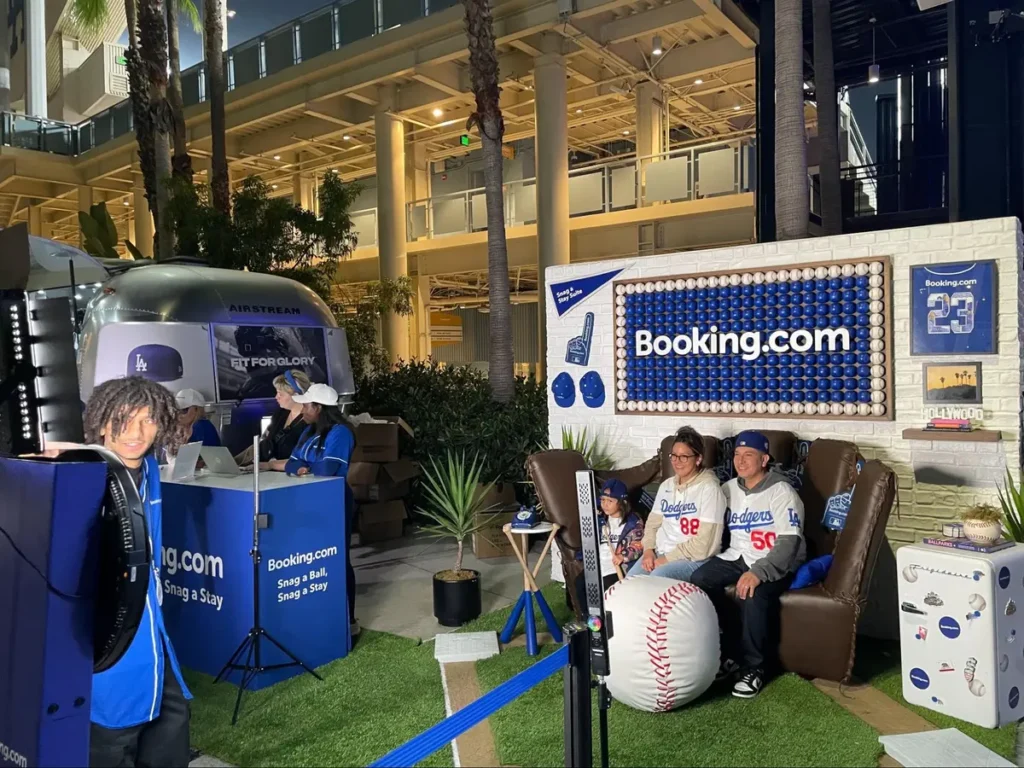 Booking.com promotional event space with Airstream trailer, baseball theme, interactive stations and comfortable seating area for guests