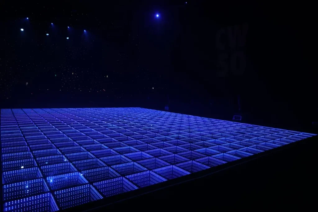 Empty blue illuminated LED dance floor in a darkened venue ready for an event