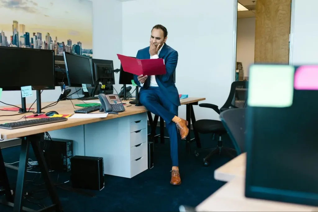 Event planner reviewing vendor contract proposal in modern office environment