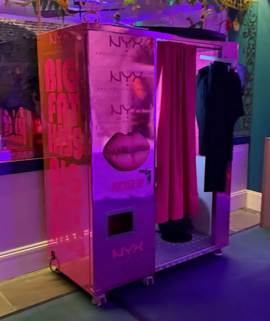 NYX Praofessional Makeup photo booth with pink lighting and 'Big Fat Lips' branding, showing creative branded activation space