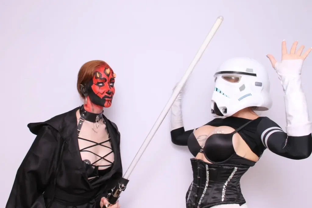 Star Wars themed photo booth with costumed attendees in Darth Maul and Stormtrooper outfits