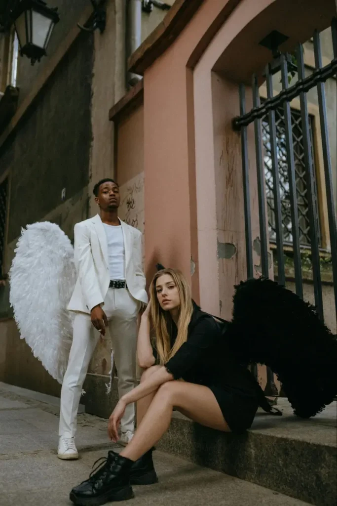Angel and demon costume concept with contrasting white and black wings, perfect for heaven and hell themed parties