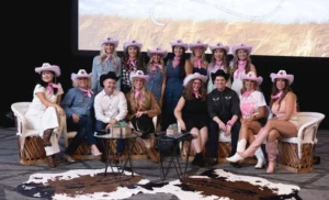 Western-themed event with group wearing matching pink cowboy hats and bandanas at Skinceuticals