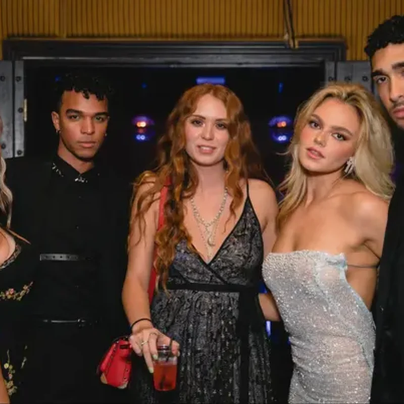 Event photography capturing group in formal attire at nightclub, showing modern low-light party photography techniques