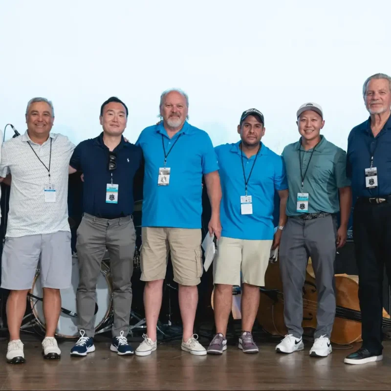 Group of colleagues posing together during a corporate team-building event.